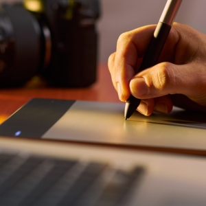 Artist Photographer Retouches Photo On Computer With Graphic Tablet
